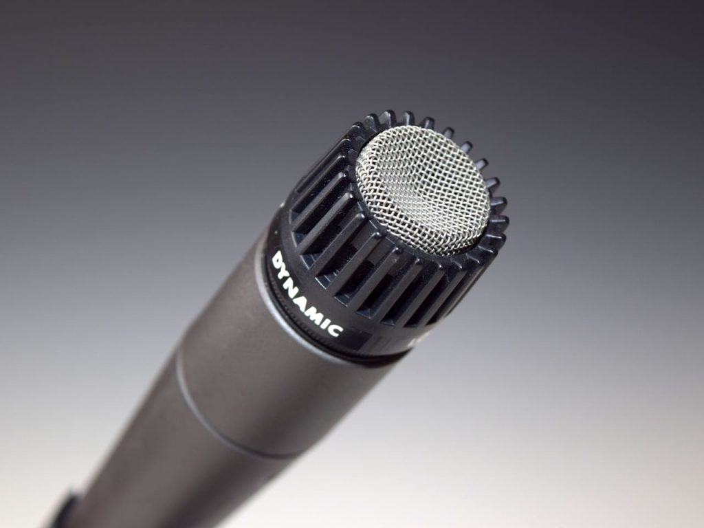 High-quality close-up of a dynamic microphone for audio recording and performance.